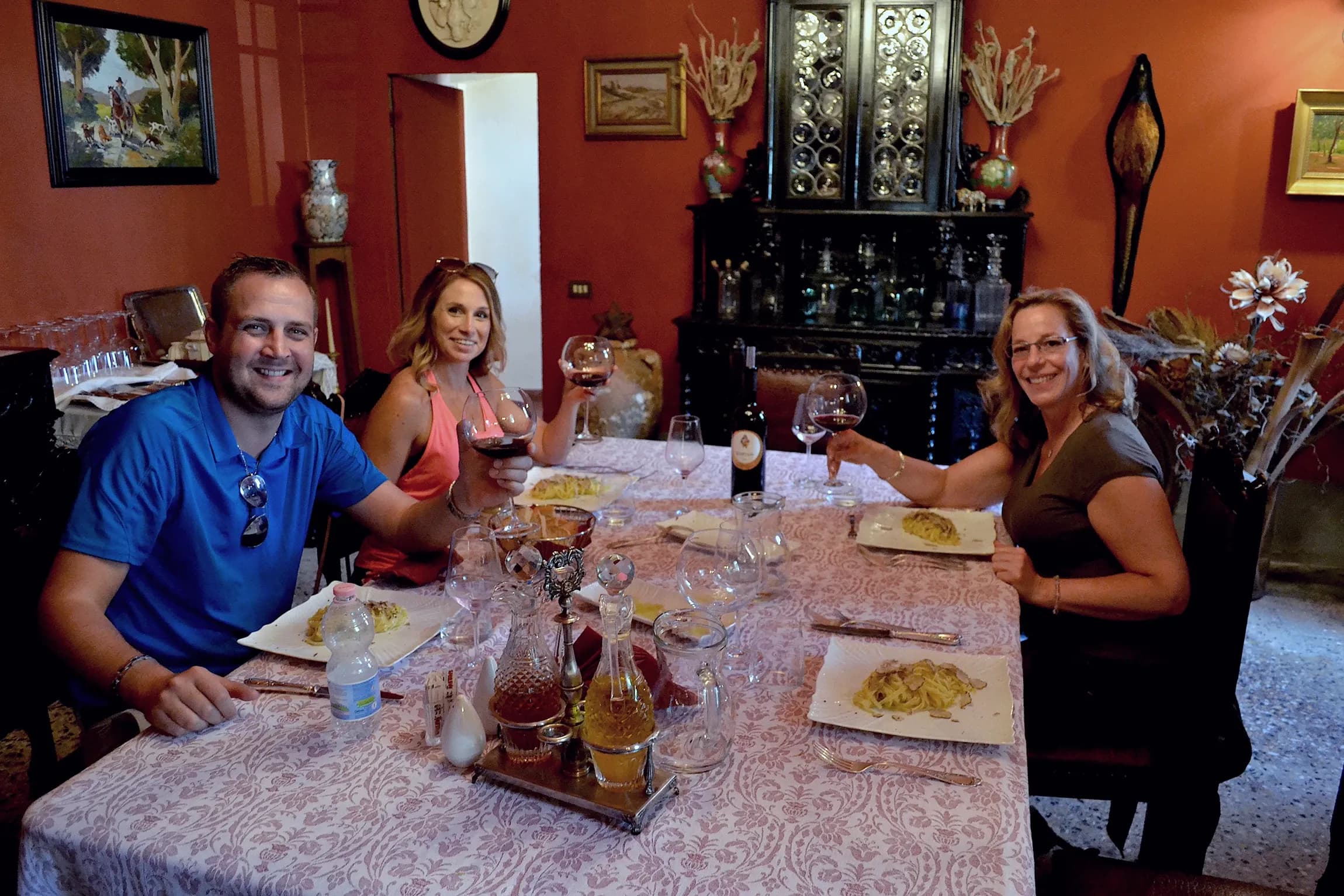 Happy guests toasting over a truffle lunch in Tuscany
