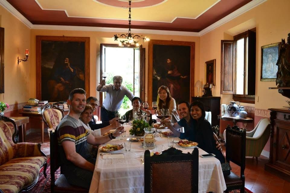 Guests around the long table for a truffle lunch in the dining room of the San Miniato villa